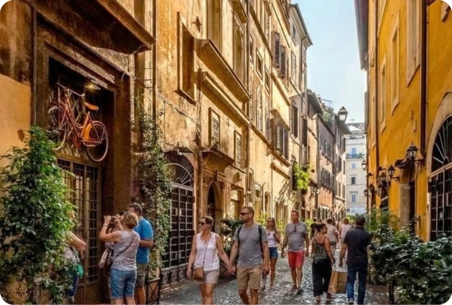 Vicolo del Rione Ponte a Roma con persone che passeggiano tra le botteghe storiche